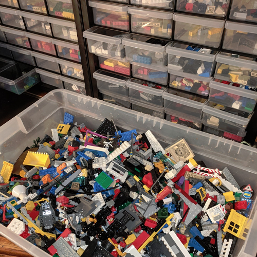 A bin and storage system  filled with Lego bircks.